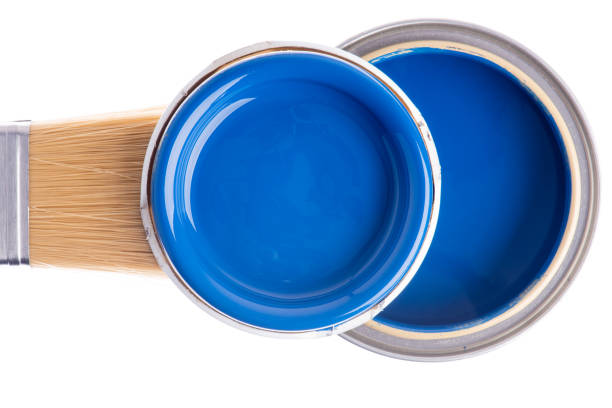 istock Opened can of blue paint with brush on white background 1356318901