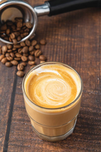 istock Cortado coffee with coffee beans next to it. Traditional coffee in Spain. 1356319088