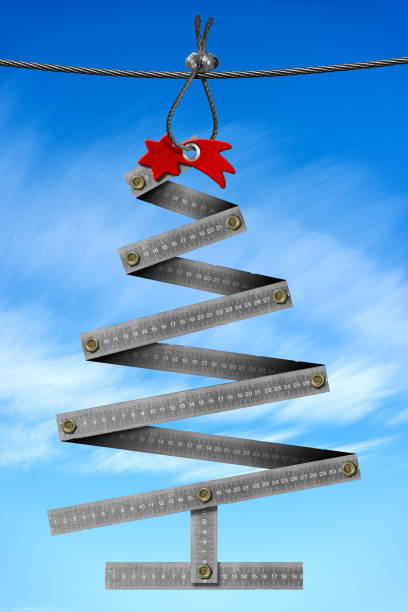 istock Metal Folding Ruler in the shape of a Christmas Tree on Blue Sky 1356321875