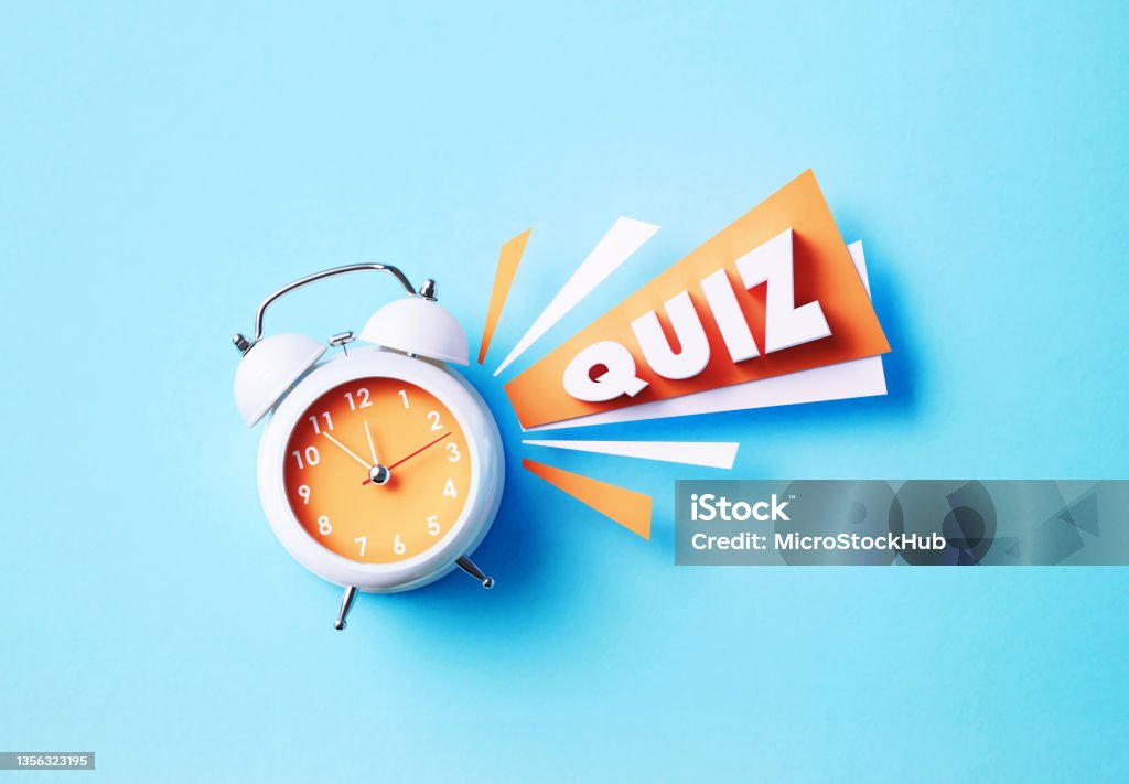 Quiz Word Sitting Next To A White Alarm Clock On Blue Background Quiz word sitting next to white alarm clock on blue background. Horizontal composition with copy space. Quiz concept. Educational Exam Stock Photo