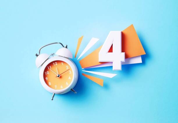 Number four sitting next to white alarm clock on blue background. Horizontal composition with copy space.