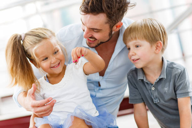 istock Happy single father enjoying with his kids at home. 1356324172