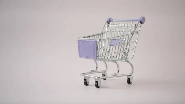 Photo of Shopping cart. Empty cart on a solid background. Concept