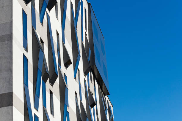 istock Modern building exterior segment in concrete and uneven protruding windows 1356326360