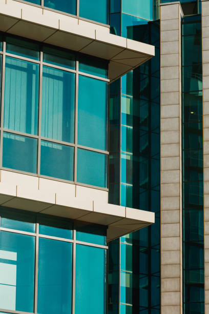 istock Blue glass windows and concrete features on modern building facade 1356326385