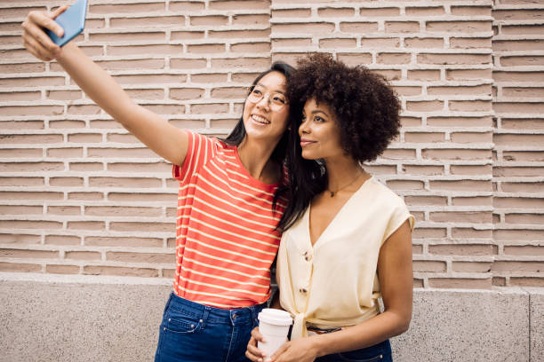 istock Two best friends on vacation in Madrid taking a selfie 1356329176