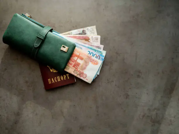 Russian money and passport. Close-up of a green wallet full of 5000, 2000, 1000, 500 rubles banknotes. The money is in your wallet.