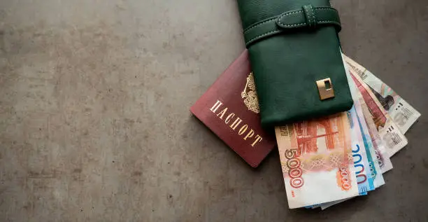 Russian money and passport. Close-up of a green wallet full of 5000, 2000, 1000, 500 rubles banknotes. The money is in your wallet.