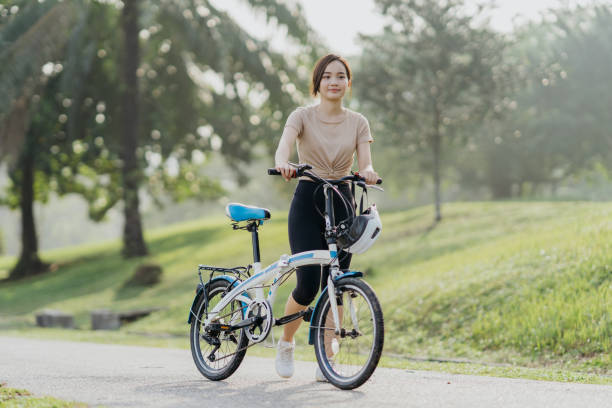 istock Young Asian women with bicycle 1356333953