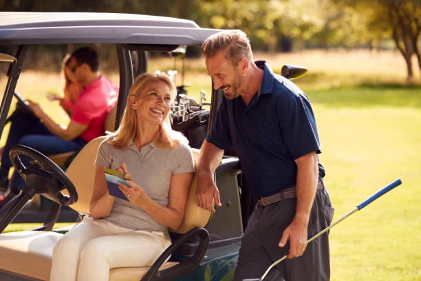 Mature And Mid Adult Couples In Buggies Playing Round On Golf Together Mature And Mid Adult Couples In Buggies Playing Round On Golf Together happiness four people cheerful senior adult stock pictures, royalty-free photos & images