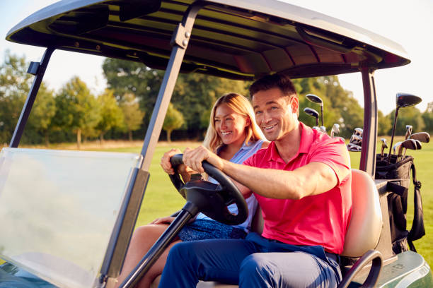 istock Couple Driving Buggy Playing Round On Golf Together 1356334797