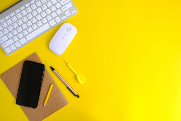 istock Flat lay minimal home office workspace. Silver keyboard notepads, Office desk table with laptop, supplies and table 1356335330