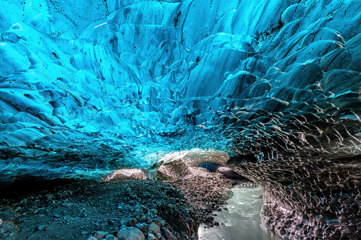 An icy river carries melt water through an ice cave in the glacier. Breioarmerkurjokull, part of the Vatnajokull glacier in southeast Iceland.