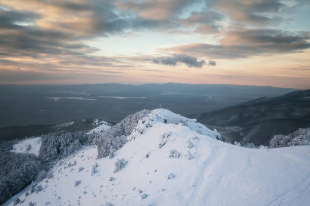 istock Winter landscape with snow-capped mountain peaks 1356336298