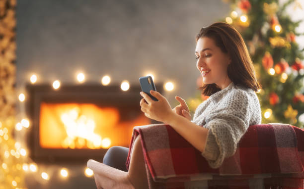 istock woman near Christmas tree 1356337122