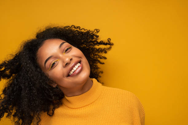 istock Happy African woman headshot 1356337640