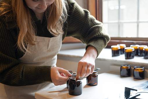 Woman working on Home Made Candle