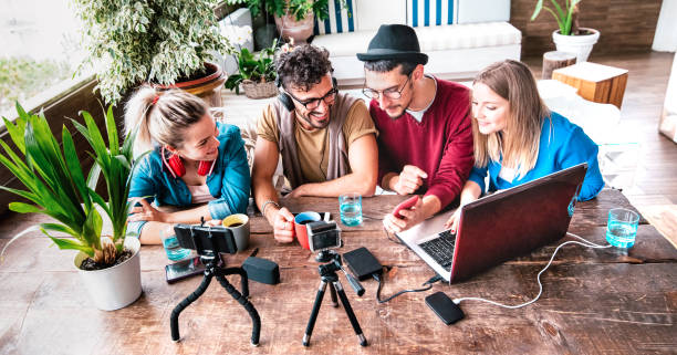 istock Milenial people sharing content on streaming platform with digital web camera - Modern lifestyle concept with smart millenial guys and girls having fun vlogging live feeds on social media networks 1356341338