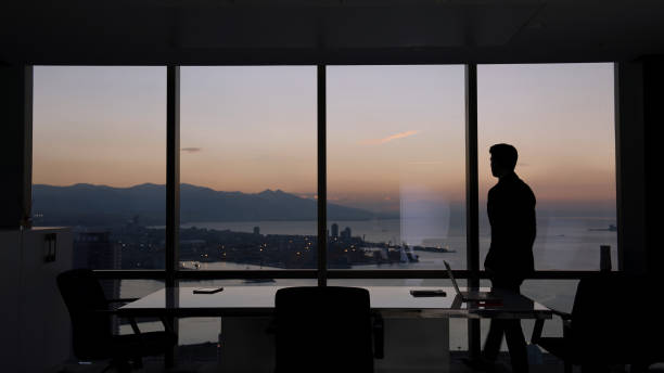 istock Businessman looking out of the window 1356342135
