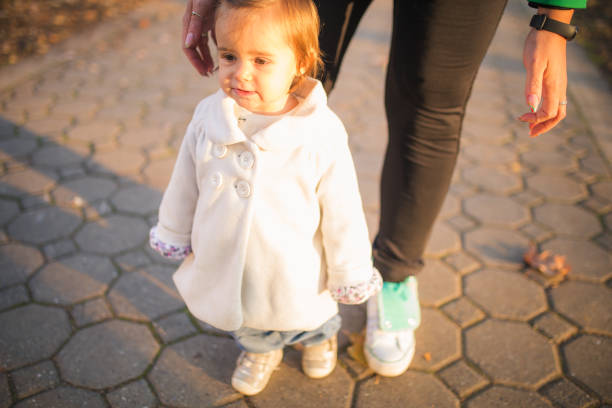 istock Mother and baby walking outside 1356342327