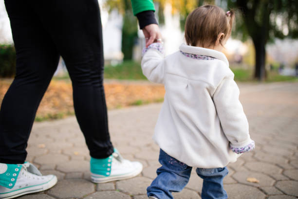 istock Mother and baby walking outside 1356342381