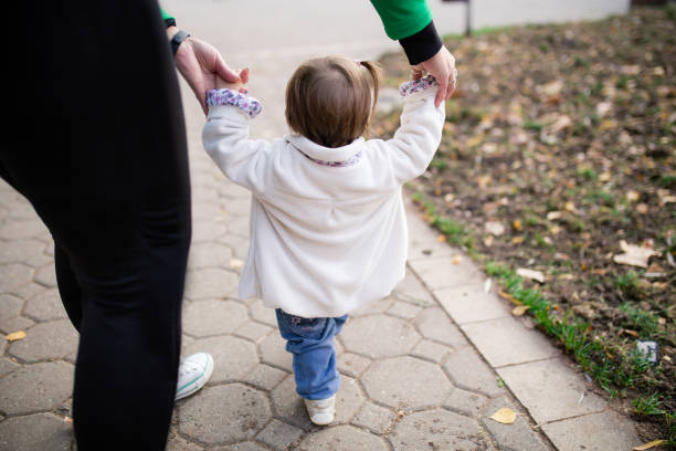 istock Mother and baby walking outside 1356342387