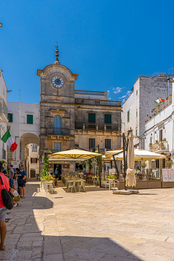 Unidentified people at the Torre dell'orologio or clock tower in Cisternino,a comune in the province of Brindisi in Puglia, South Italy, known for its Salento wine
