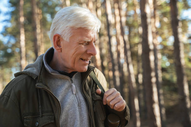 istock Cheerful old man feeling freedom while traveling in forest 1356343587
