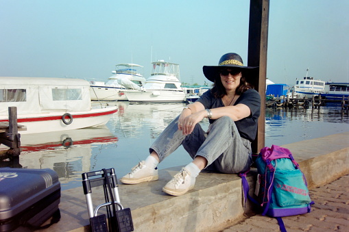 Java, Indonesia, September 1991. A tourist is waiting at the marina for the transfare with the speedboad to the\