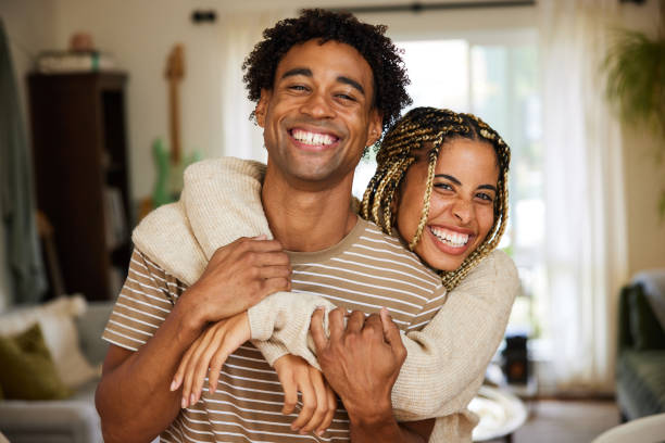 istock Affectionate young woman hugging her boyfriend at home 1356343900