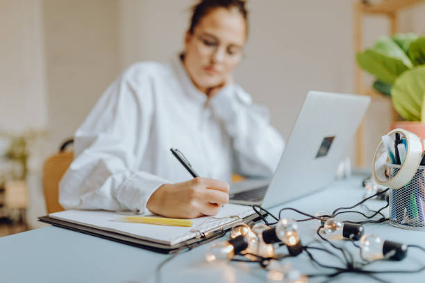 istock Happy young Woman in her Home Office and Using her Laptop 1356345169