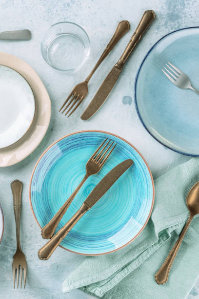 Blue plate and other tableware, shot from above on a table Blue plate and other tableware, shot from above on a table. Elegant dinner service restaurant place setting dinner dinner party stock pictures, royalty-free photos & images