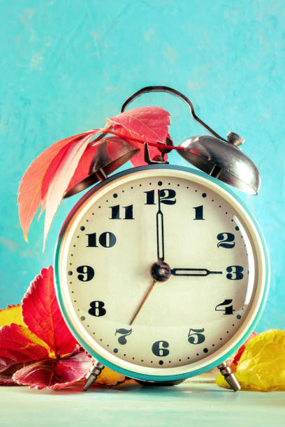 istock Daylight Savings Time concept, fall back in autumn. A vintage alarm clock 1356345294