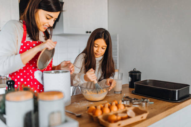 istock Mom with daughter on kitchen 1356347059