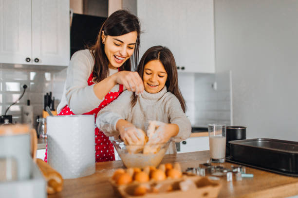 istock Mom with daughter on kitchen 1356347305