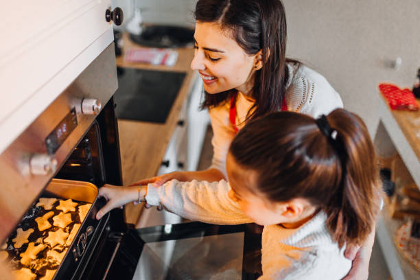 istock Mom with daughter on kitchen 1356347374
