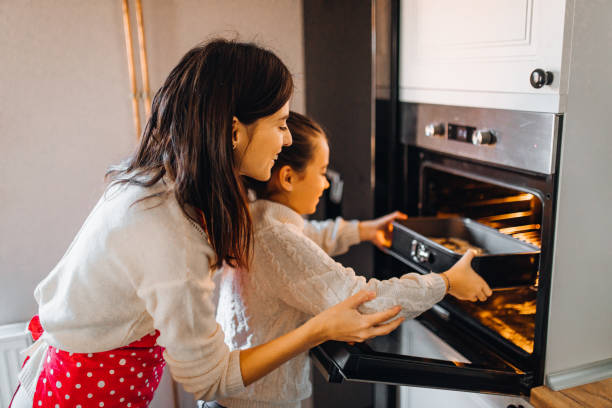 istock Mom with daughter on kitchen 1356347401