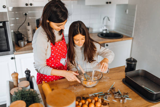 istock Mom with daughter on kitchen 1356348037
