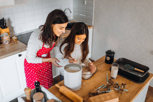 istock Mom with daughter on kitchen 1356348173