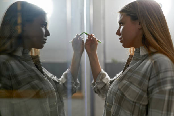 istock Young creative woman writing plans on a glass wall. 1356348201
