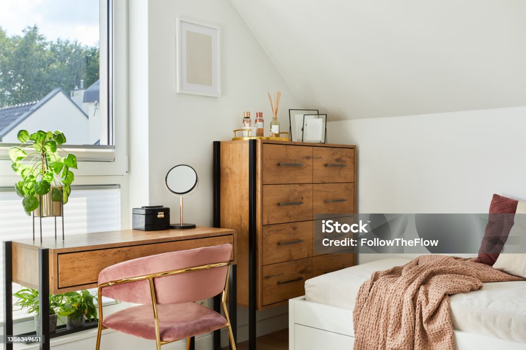 Modern teenage room interior design with bed, table, chest of drawers, pink velvet chair and personal accessories. Template. Dresser Stock Photo