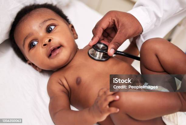 Shot Of A Little Baby At A Checkup With A Doctor At A Clinic Stock Photo - Download Image Now