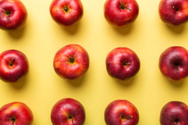 istock Many red apples on colored background, top view. Autumn pattern with fresh apple above view 1356350104