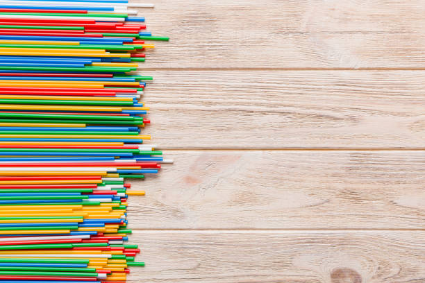 istock Heap of colorful plastic drinking straws on Colored background, flat lay. Copy Space for text 1356350201