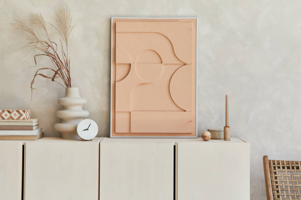 istock Creative composition of modern beige living room interior design with designed sculptures, structure painting, beige wooden sideboard and boho inspired personal accessories. Template. 1356351420