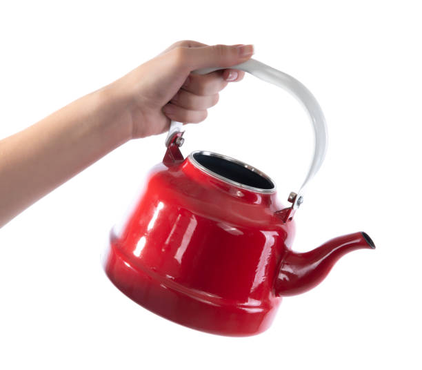 Hand holding tea kettle isolated on white background