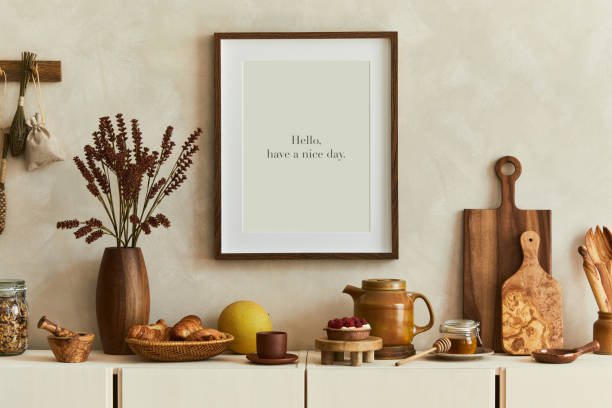 istock Stylish and modern kitchen interior composition with mock up poster frame, beige wooden sideboard, plants and retro inspired accessories. Template. Autumn vibes. 1356352558