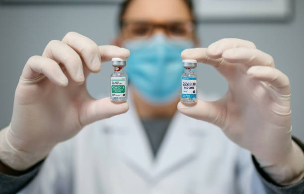 istock Doctor showing two coronavirus vaccine options 1356352944