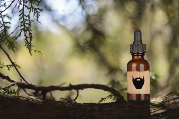 istock Beard Balm Or Oil on a blurry forest background. 1356353000