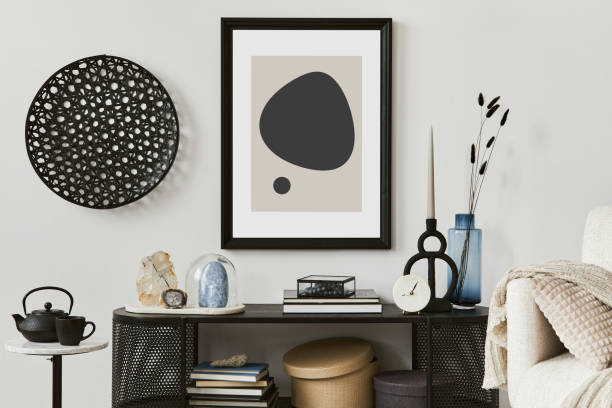 istock Creative composition of living room interior design with console, armchair, mock up poster frame, vase, gemstone and vintage personal accessories. Copy space. Template. 1356354321